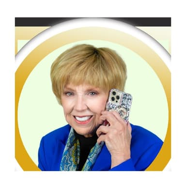 Dr. Jan Duffy, Las Vegas REALTOR, smiling on a phone call in a royal blue blazer, photographed for Grand Park Village Homes in West Summerlin, Las Vegas, Nevada. Shown with her note at the end of the page.